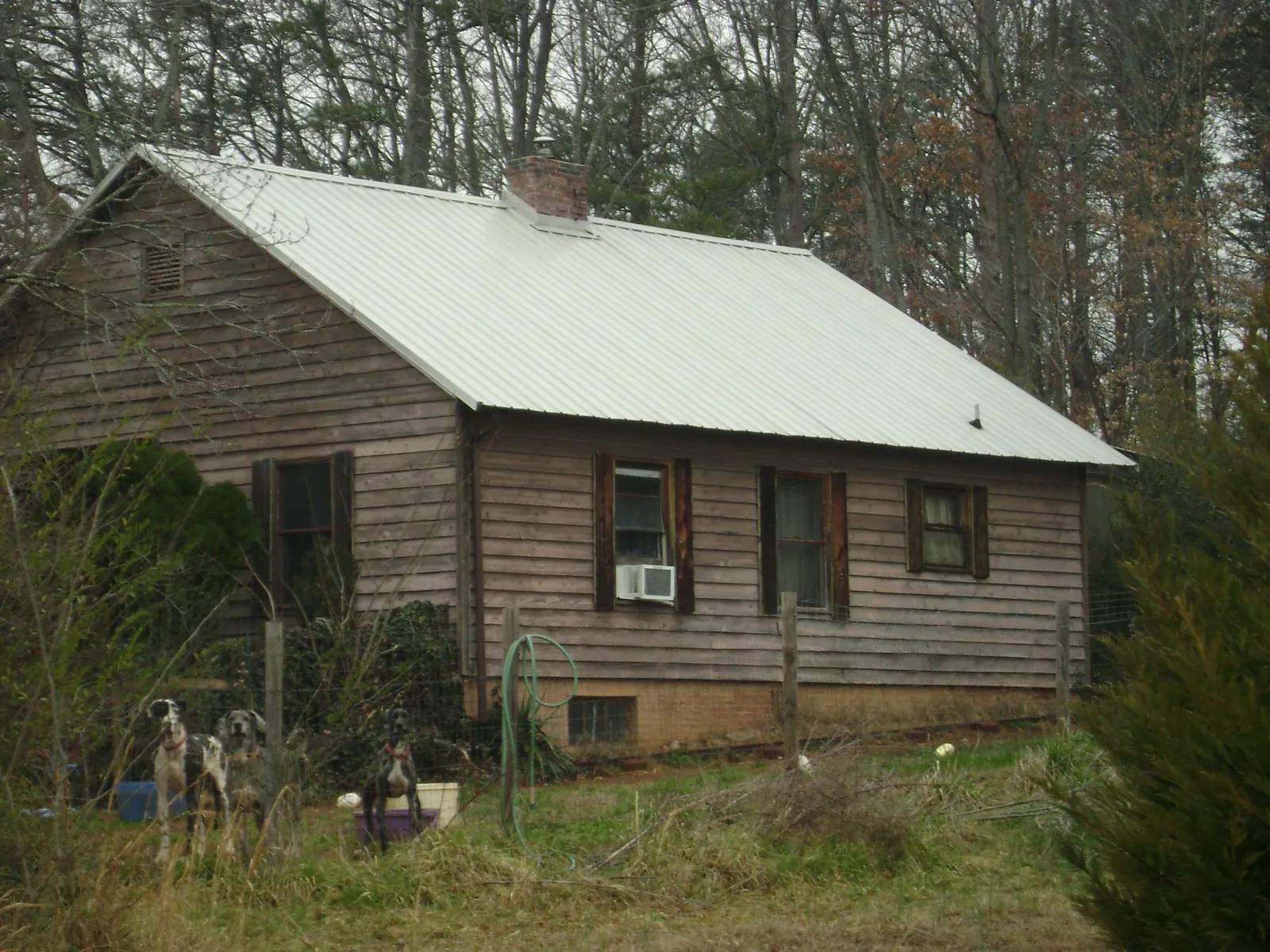 White metal roof on an old wood sided farmhouse, from a Metal Roof Installation job in Inman